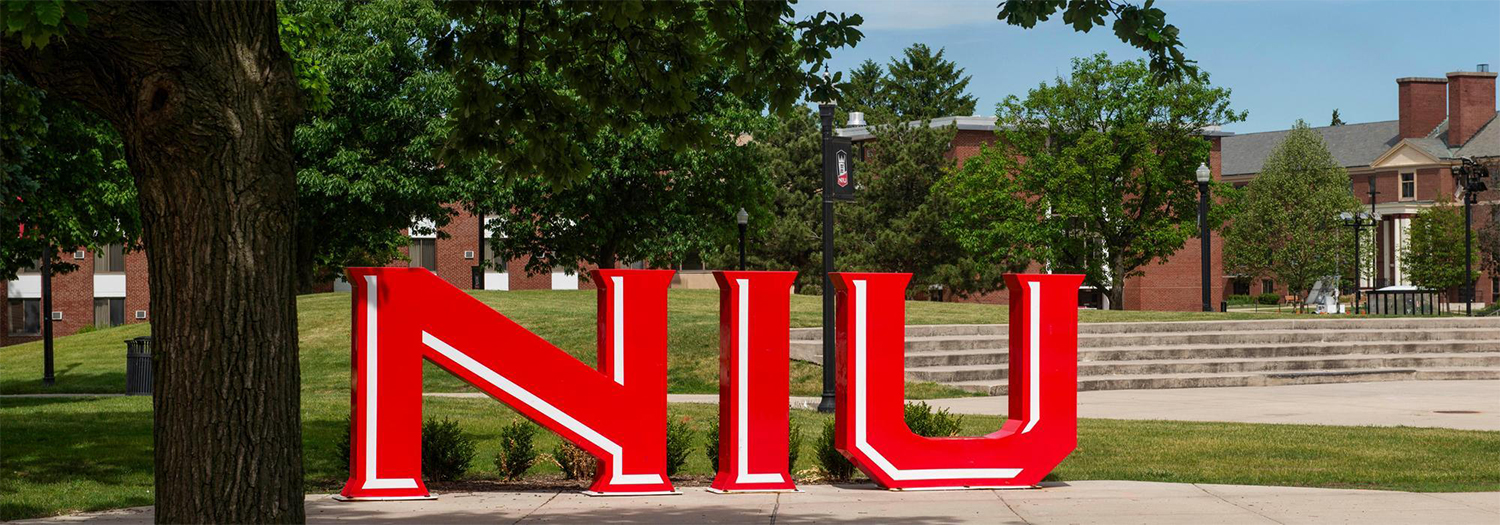 Provost leadership team in front of NIU letter sculpture.
